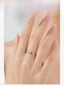 Model wearing a delicate 925 sterling silver star ring on index finger with elegant details