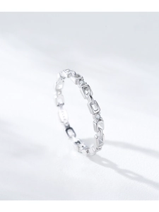 Macro shot of S925 sterling silver chain ring with pavé crystals and hollowed geometry