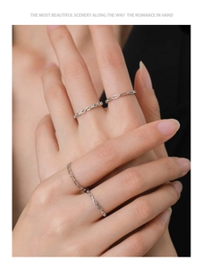 Close-up of three S925 sterling silver minimalist geometric rings worn by a model