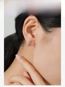 Close-up of elegant S925 sterling silver double heart stud earrings worn by a model