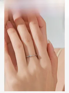 Gros plan sur la bague Mobius minimaliste en argent massif portée par le modèle