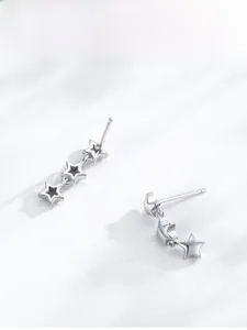 Detail view of 925 sterling silver star drop earrings with triple star dangle design
