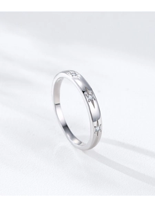 Detail view of 925 sterling silver ring with engraved stars and embedded small zircons