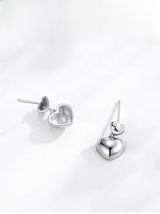Detailed close-up of polished S925 sterling silver double heart-shaped stud earrings