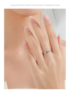 Macro detail of 925 sterling silver star ring with dainty pave zircon on a model hand
