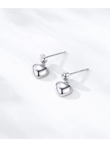 Macro detail of S925 sterling silver heart earrings with polished finish and hallmark