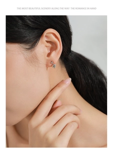 Close-up of double heart S925 sterling silver stud earrings worn on a model ear