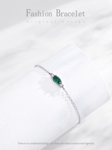 Detailed macro shot of vintage S925 silver bracelet with oval green zircon and side gems