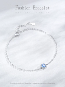 Detail of S925 silver bracelet featuring a halo-set blue zircon and lobster clasp