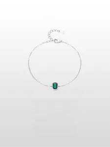 Close-up of S925 sterling silver bracelet with emerald-cut green stone and lobster clasp