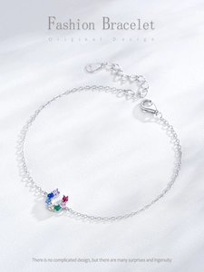 Macro shot of S925 sterling silver bracelet with horseshoe charm and colorful gemstones