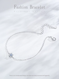 Detailed macro shot of S925 silver bracelet featuring blue and white zircon flower pendant