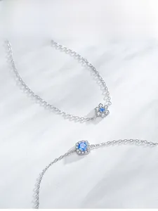 Detailed macro view of S925 silver bracelets featuring blue floral and octagonal charms