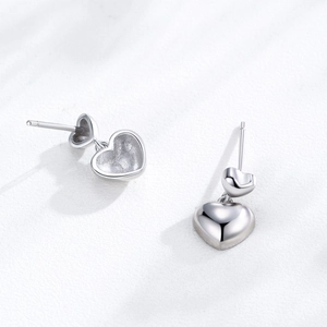 Minimalist S925 sterling silver heart stud earrings with a double-heart polished design