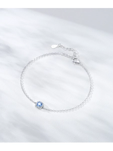 Detail of S925 sterling silver bracelet featuring a blue zircon in a halo setting