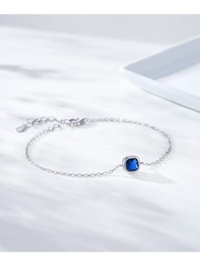 Close-up of S925 sterling silver bracelet with a square blue gemstone and hallmark