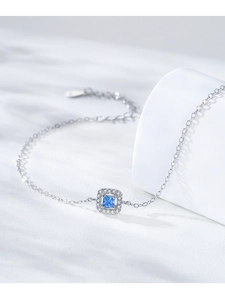 Macro detail of S925 silver bracelet featuring a square blue zircon and halo setting