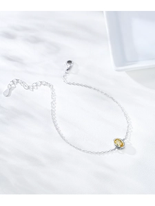 Detailed macro view of S925 sterling silver chain with an amber yellow oval zircon stone
