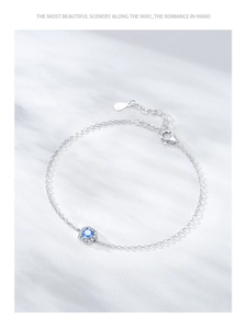 Detailed macro view of S925 sterling silver bracelet with blue zircon and lobster clasp