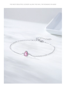 Macro shot of S925 sterling silver chain with pink teardrop-shaped zircon and lobster clasp