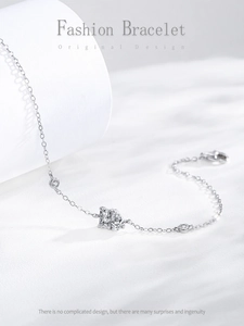 Close-up of 925 silver chain bracelet featuring square and teardrop crystal charms