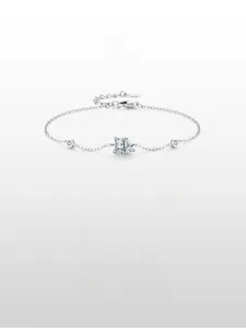 Macro detail of 925 silver chain bracelet featuring rectangular and pear-cut crystals