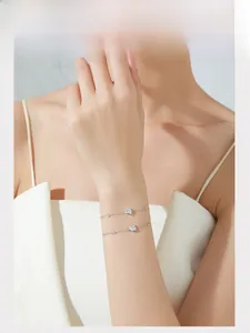 Close-up of adjustable S925 sterling silver bracelets with geometric zircon charms