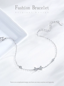 Detailed macro view of S925 sterling silver bow bracelet with sparkling zircon stones
