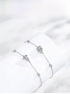 Detail shot of S925 silver bracelet featuring cubic zirconia butterfly and round charms