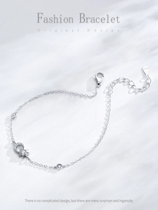 Macro view of S925 sterling silver sun and moon bracelet with shimmering cubic zirconia