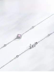 Detailed macro of S925 silver bracelet with pink zircon and Love pendant charm
