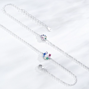S925 sterling silver horseshoe bracelet with colorful zircon snail charms on white fabric