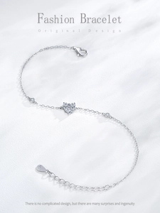 Detailed view of S925 sterling silver heart bracelet with sparkling cubic zirconia charms