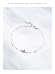 Macro detail of 925 sterling silver butterfly bracelet with shimmering pave crystals