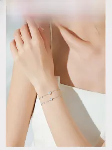 Close-up of S925 sterling silver double-layer heart bracelet with sparkling zircon on wrist