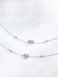 Detail of S925 sterling silver heart-shaped cubic zirconia bracelet with delicate cross chain