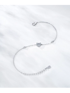 Detail of S925 sterling silver heart bracelet with sparkling stones on white surface