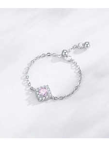 Macro shot of S925 silver adjustable chain ring with pink zircon and halo setting