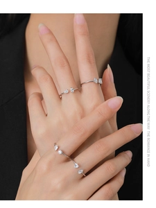 Close-up of four-piece S925 silver rings with sparkling zircon on a model's hand