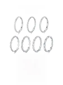 Detail of seven S925 sterling silver rings with geometric and hollow minimalist designs