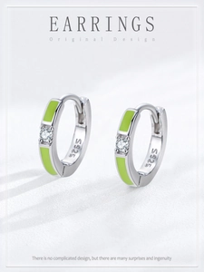 Macro detail of S925 sterling silver hoop earrings with green enamel and zircon stone