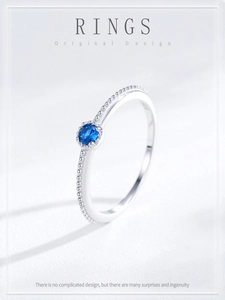 Macro shot of S925 sterling silver ring with blue sapphire zircon and beaded texture