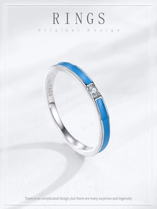 Detail of S925 sterling silver ring with blue enamel and small zircon stone inlay