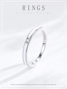 Detail of S925 sterling silver ring with white enamel inlay and small zircon stone