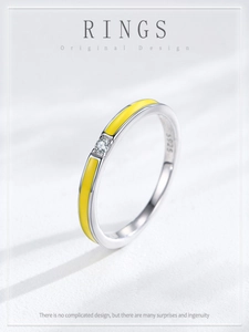 Detail of S925 sterling silver ring featuring yellow enamel and a tiny centered zircon