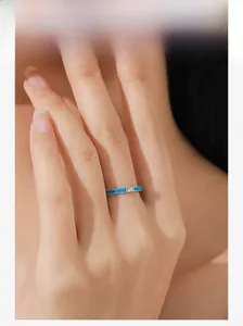 Close-up of S925 sterling silver ring with blue enamel and small diamond on model hand