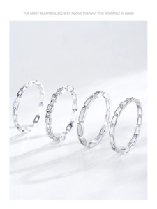 Detail of four S925 sterling silver minimalist geometric rings with micro-zircon accents