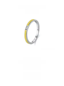 Macro shot of S925 sterling silver ring with yellow enamel and a small white zircon stone