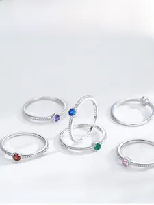 Detailed view of S925 sterling silver thin rings with multi-color zircon stone settings