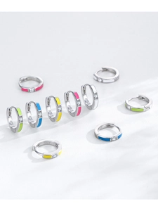 Macro detail of S925 silver hoop earrings with neon enamel and sparkling cubic zirconia
